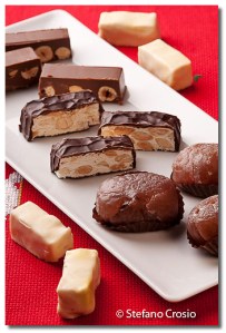 Chocolate-coated torrone, chocolate torrone with hazelnuts and marrons glacés